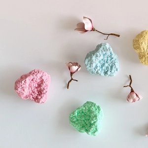 Macro view of heart-shaped 3D resin rock molds in pastel pink, blue, and green tones