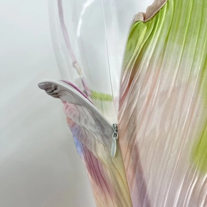 Macro detail of high-quality invisible zipper on a gradient pleated slim-fit dress