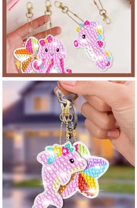 Detail of DIY diamond painting keychains featuring dolphin and pink cartoon character shapes