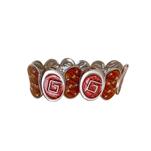Bracelet vintage argenté avec motif étoile et émail rouge au design spirale