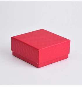 Detail view of the red jewelry gift box featuring a fine diamond texture on a white background