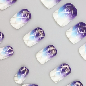 Macro detail of purple gradient press-on nails with silver grid patterns and silver glitter