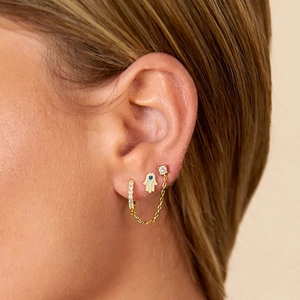 Detailed close-up of S925 silver gold-plated Hamsa hand and CZ stud earring set