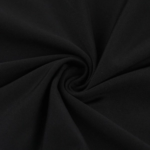 Close-up of the black knitted fabric texture showing premium stitching and material