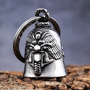 Gothic skull motorcycle wing bell pendant in silver finish on textured wood surface