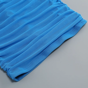Detailed close-up of blue mesh fabric featuring ruched texture and precise stitching
