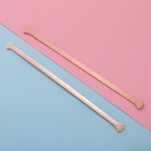 Detailed view of rose gold cat claw handle long bar bracelet on a two-tone background