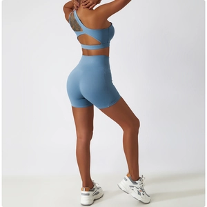 Detail of yoga set showing high waist shorts with side pocket in dusty blue