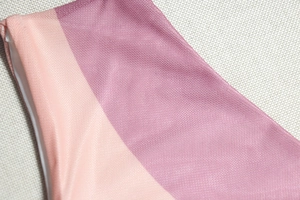 Close-up of the breathable pink gradient mesh fabric with refined stitching and texture
