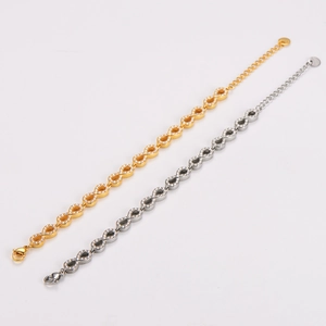 Elegant gold and silver infinity bracelets with cubic zirconia on white background