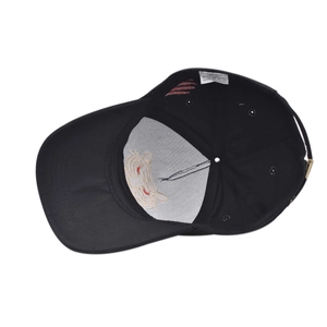 Detail showing the internal structure and tiger embroidery backing of a cotton baseball cap
