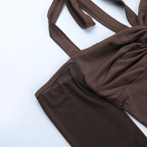 Detail of dark brown mesh stitching and fabric texture on a long-sleeve shoulder top