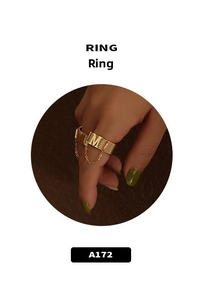 Macro shot of 18k gold plated ring featuring wide vertical texture and letter M charm
