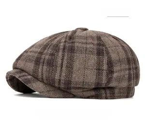 Close-up of khaki plaid wool newsboy cap showing twill texture and warm fabric detail