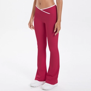 Detail of red flare yoga pants featuring V-cross high waist and white contrast piping