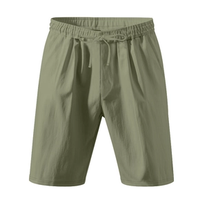 Detail view of olive green linen shorts with drawstring waist and textured fabric