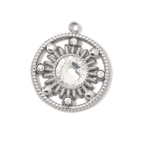 Detailed view of silver stainless steel sunburst pendant with sparkling crystals