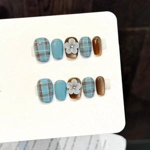 Handmade press-on nails featuring blue and amber plaid with 3D embossed flowers