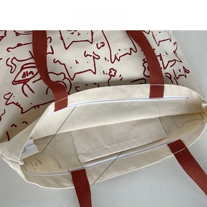 Internal view of canvas tote bag showing the top zipper and handy inner phone pocket