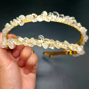 Macro detail of handmade gold wire crown headband featuring raw natural crystal stones