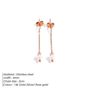 Detailed view of stainless steel drop earrings with pearl pendant and rose gold finish
