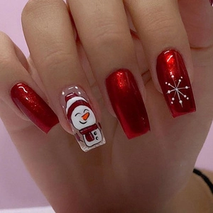 Detail of festive long ballet press-on nails featuring a cute snowman and snowflake design
