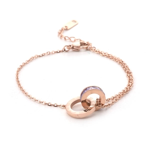 Bracelet en or rose à doubles anneaux entrelacés avec chiffres romains et zircons mauves