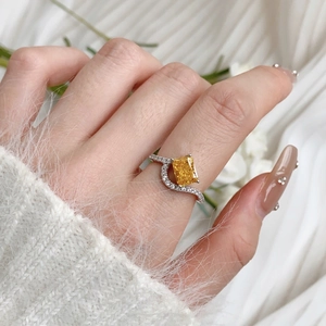 Close-up of elegant S925 silver ring featuring a rectangular yellow zircon and pave diamonds