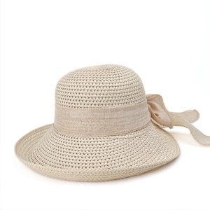 Detail of the woven texture and large elegant bow on this stylish summer straw sun hat
