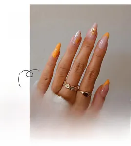 Macro detail of long stiletto press-on nails with yellow floral patterns and French tips