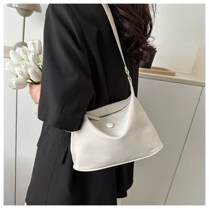 Modern white Oxford fabric crossbody bag shown on a model in a minimalist studio setting