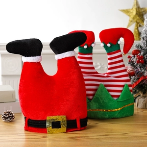 Close-up of festive funny Christmas hats with red legs and sequins on a wooden table
