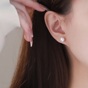 Elegante weiße Süßwasserperlen-Ohrstecker am Modell mit S999 Silber Schraubverschluss