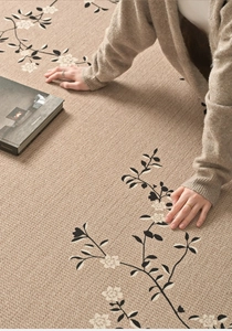 Detailed texture of apricot knitted floral rug with elegant black branch patterns