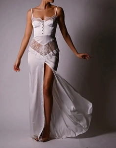 Detail of white satin dress featuring intricate lace trim and front buttons on the bodice