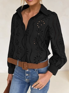 Detail of floral embroidery and hollow-out lace design on black puff sleeve cardigan