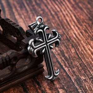 Macro shot of gothic engraved stainless steel cross pendant with aged silver finish