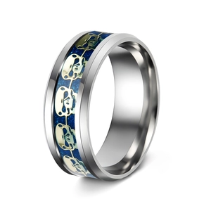 Close-up of gothic skull pattern ring with deep blue starry background and silver finish