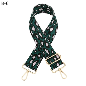 Detail of green and pink leopard print woven strap with gold metal buckles for bags