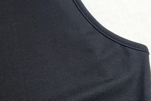 Detailed close-up of the stitching and knit texture on this black bodycon dress neckline