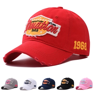 Detail of vintage distressed cotton baseball caps with 1968 embroidery in multiple colors