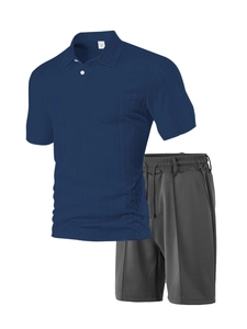 Detail of dark blue waffle knit polo shirt and charcoal sports shorts with drawstring
