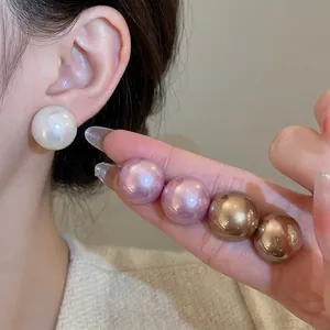 Elegant large pearl stud earrings set in white pink and gold colors for women