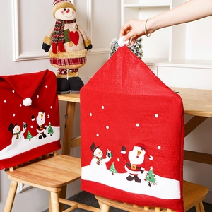 Detailed view of red non-woven Christmas chair covers with Santa and snowman prints