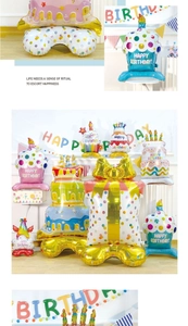 Detail view of colorful layered cake and gift box foil balloons for birthday party setup