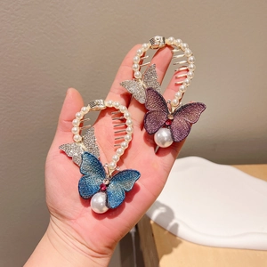 Detail of blue and purple embroidered butterfly hair claw with pearls and rhinestones