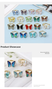 Detailed close-up of multi-color crystal butterfly rings with adjustable gold-plated bands