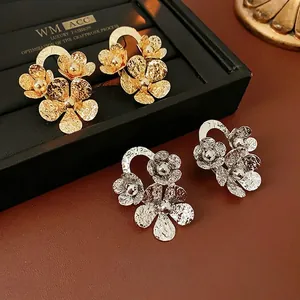 Textured metallic floral earrings in gold and silver finish with hammered petal design