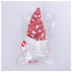 Dettaglio dello gnomo di Natale in peluche con cappello rosso e barba bianca in confezione