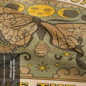 Close-up of bohemian tapestry fabric showing celestial sun, moon and moth patterns
